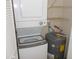 Laundry closet features stacked washer and dryer with water heater at 3311 Teeside Dr, New Port Richey, FL 34655