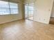 Living room features tile floors, large window, and sliding door to sunroom at 3311 Teeside Dr, New Port Richey, FL 34655