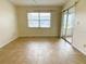 The living room features tile flooring, a large window, and sliding glass doors for natural light at 3311 Teeside Dr, New Port Richey, FL 34655