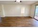 Large living room featuring wood-look floors, access to an outside patio, and a ceiling fan at 3311 Teeside Dr, New Port Richey, FL 34655