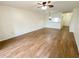 Living room featuring wood-look floors, access to other rooms, and a ceiling fan at 3311 Teeside Dr, New Port Richey, FL 34655