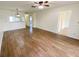 Open living room with wood-look floors, easy access to other rooms, and a ceiling fan at 3311 Teeside Dr, New Port Richey, FL 34655