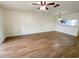 Spacious living room featuring wood-look flooring and a ceiling fan at 3311 Teeside Dr, New Port Richey, FL 34655
