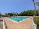 Spacious community pool offering plenty of lounge seating and mature tropical landscaping at 3311 Teeside Dr, New Port Richey, FL 34655
