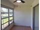 Enclosed sunroom featuring tile flooring, textured walls and views outside at 3311 Teeside Dr, New Port Richey, FL 34655
