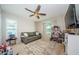 Well-lit room featuring a cozy couch, ceiling fan, and an arched window at 382 Tavernier Cir, Oldsmar, FL 34677