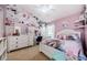 Charming bedroom with flower wall decor, white furniture, and unique unicorn artwork at 382 Tavernier Cir, Oldsmar, FL 34677