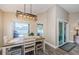 Cozy dining area with modern light fixture, wood-look floors, and sliding glass doors to outdoor living space at 382 Tavernier Cir, Oldsmar, FL 34677