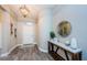 Inviting foyer featuring stylish wood-look floors, modern light fixtures, and neutral wall paint at 382 Tavernier Cir, Oldsmar, FL 34677