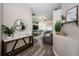 Bright foyer flowing into the living room, showcasing wood-look floors and neutral decor at 382 Tavernier Cir, Oldsmar, FL 34677