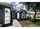 Close-up of the front door, landscaping and the column-style accents on the porch at 382 Tavernier Cir, Oldsmar, FL 34677