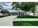 Charming single-Gathering home with mature trees, a well-manicured lawn, and an attached garage at 382 Tavernier Cir, Oldsmar, FL 34677