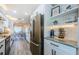 Well-designed kitchen with stainless steel appliances, marble counters, and shelving at 382 Tavernier Cir, Oldsmar, FL 34677