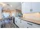 Stylish kitchen with white cabinets, stone countertops and stainless steel appliances at 382 Tavernier Cir, Oldsmar, FL 34677