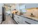 Beautiful kitchen featuring marble countertops, white cabinets and subway tile backsplash at 382 Tavernier Cir, Oldsmar, FL 34677