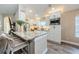 Kitchen island features a marble countertop, bar stools, and bright recessed lighting at 382 Tavernier Cir, Oldsmar, FL 34677