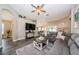 Comfortable living room with ceiling fan, wood-look floors, and access to the dining area at 382 Tavernier Cir, Oldsmar, FL 34677