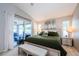 Serene main bedroom with plush bedding, ample natural light, and access to a private patio at 382 Tavernier Cir, Oldsmar, FL 34677