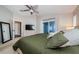 Comfortable main bedroom with a ceiling fan, plush bedding, and access to a covered patio at 382 Tavernier Cir, Oldsmar, FL 34677