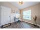 Bright home office featuring wood-look floors, ample natural light, and a vaulted ceiling at 382 Tavernier Cir, Oldsmar, FL 34677