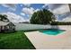Pool and playground area with white fence and playhouse in the yard at 382 Tavernier Cir, Oldsmar, FL 34677