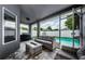 Relaxing screened patio features a cozy seating area with views of the beautiful pool at 382 Tavernier Cir, Oldsmar, FL 34677