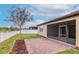 Landscaped backyard features a screen patio, a white fence, green lawn, and wood mulch at 3914 Round Table Ct, Land O Lakes, FL 34638