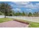 Grassy backyard with white fence, mulch and trees at 3914 Round Table Ct, Land O Lakes, FL 34638