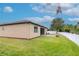 Well-maintained backyard with green lawn, screened patio, and sturdy privacy fencing for outdoor enjoyment at 3914 Round Table Ct, Land O Lakes, FL 34638