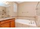 Well-appointed bathroom featuring a soaking tub and shower at 3914 Round Table Ct, Land O Lakes, FL 34638