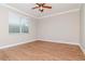 Bright bedroom featuring wood floors, a window for natural light, and a ceiling fan at 3914 Round Table Ct, Land O Lakes, FL 34638