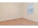 A cozy bedroom with neutral walls, carpet flooring, and a window for natural light at 3914 Round Table Ct, Land O Lakes, FL 34638