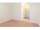 Bedroom featuring neutral paint, carpet flooring, and views into the bathroom at 3914 Round Table Ct, Land O Lakes, FL 34638