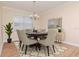 A cozy dining room area featuring modern furnishings, decor, and chandelier lighting at 3914 Round Table Ct, Land O Lakes, FL 34638