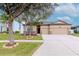 Charming single-Gathering home featuring a well-manicured lawn and a spacious three-car garage at 3914 Round Table Ct, Land O Lakes, FL 34638