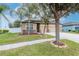 Beautiful home featuring a well-maintained lawn, a three-car garage, and swaying palm trees for added appeal at 3914 Round Table Ct, Land O Lakes, FL 34638