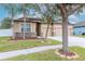 Inviting exterior of a home with a three-car garage, landscaped front yard, and stone accents creating a welcoming look at 3914 Round Table Ct, Land O Lakes, FL 34638