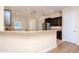 Bright kitchen featuring granite countertops, stainless steel appliances, and dark wood cabinets at 3914 Round Table Ct, Land O Lakes, FL 34638