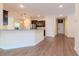 A spacious kitchen with bar seating that is open to the living room and front entry at 3914 Round Table Ct, Land O Lakes, FL 34638