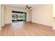 A bright living room with modern wood floors and sliding glass doors that open to a screened porch at 3914 Round Table Ct, Land O Lakes, FL 34638