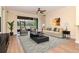 A living room with modern furnishings, stylish decor, and sliding glass doors that open to a screened porch at 3914 Round Table Ct, Land O Lakes, FL 34638