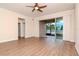 Open living room with wood floors and sliding glass doors to the screened porch at 3914 Round Table Ct, Land O Lakes, FL 34638