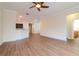 A bright living room with modern wood floors that opens to a modern kitchen and bedroom hallway at 3914 Round Table Ct, Land O Lakes, FL 34638