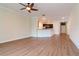 A bright living room with modern wood floors that opens to a modern kitchen and front entry at 3914 Round Table Ct, Land O Lakes, FL 34638