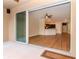 A spacious living room and kitchen area with modern wood floors seen through sliding glass doors at 3914 Round Table Ct, Land O Lakes, FL 34638