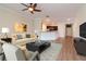 A bright living room with modern furnishings and stylish decor that opens to a modern kitchen at 3914 Round Table Ct, Land O Lakes, FL 34638