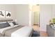 Main bedroom with a bed, nightstand, and artwork, with views into the bathroom at 3914 Round Table Ct, Land O Lakes, FL 34638