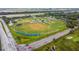Aerial view highlighting a community's baseball fields and local roads surrounded by lush greenery and trees at 3922 Fontainebleau Dr, Tampa, FL 33634