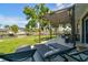 Beautiful backyard with grass, deck chairs and dining area near canal with dock and clear blue skies at 3922 Fontainebleau Dr, Tampa, FL 33634