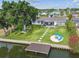 Enjoy outdoor living in this home's manicured backyard with a fire pit, waterfront access, and mature trees at 3922 Fontainebleau Dr, Tampa, FL 33634